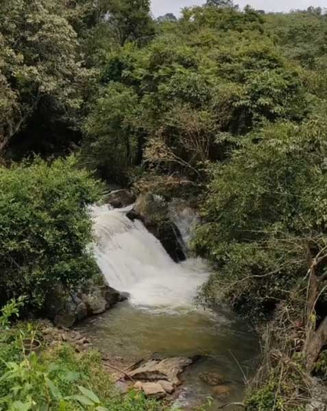 Manjehalli Waterfalls cascading down the rocky terrain amidst the serene natural surroundings of Sakleshpur